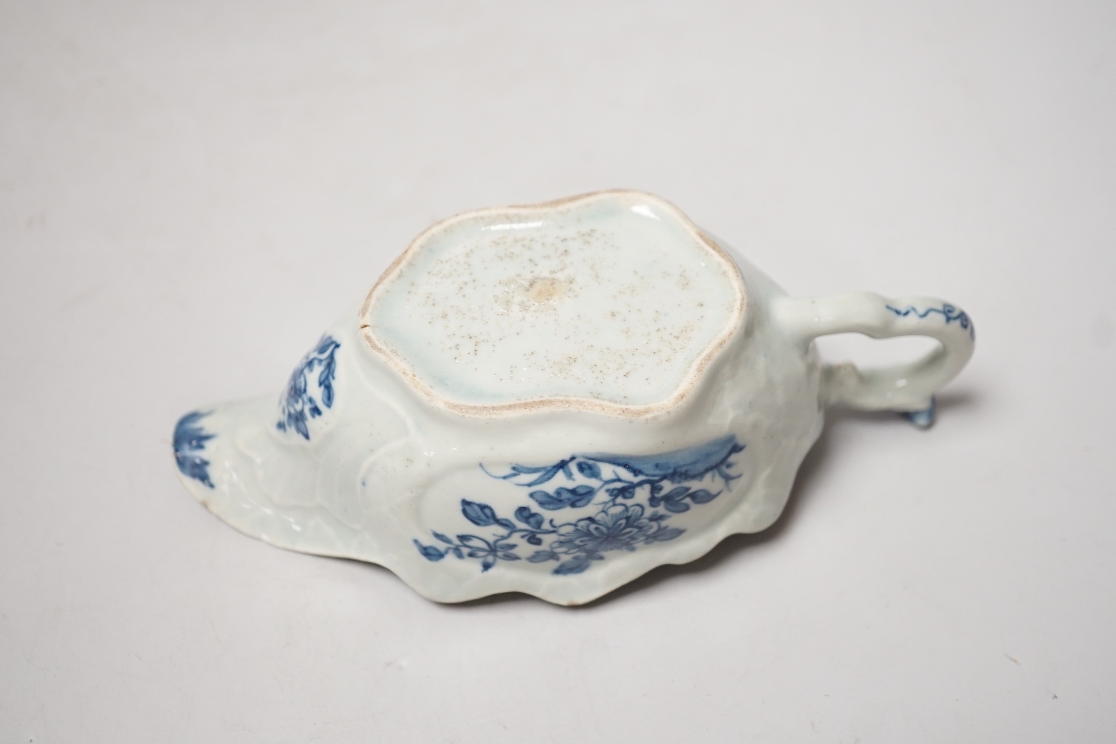 A Liverpool porcelain blue and white sauceboat and a Worcester teapot. Tallest 12cm